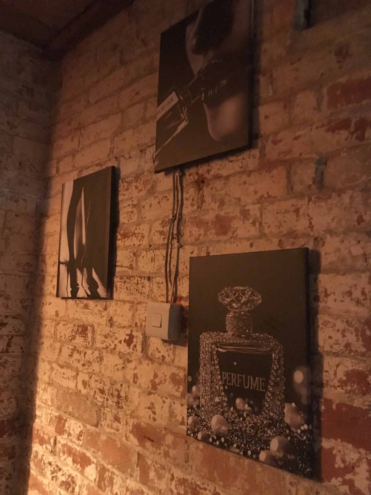 Framed prints on the exposed brick wall of the lounge