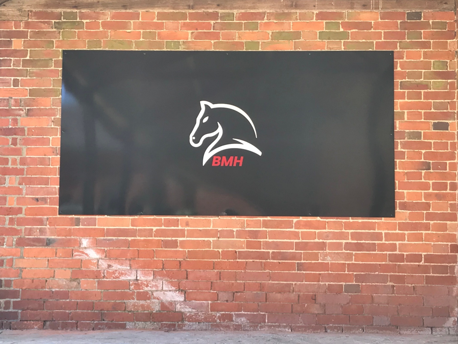 Large BMH sign on the brick stable wall