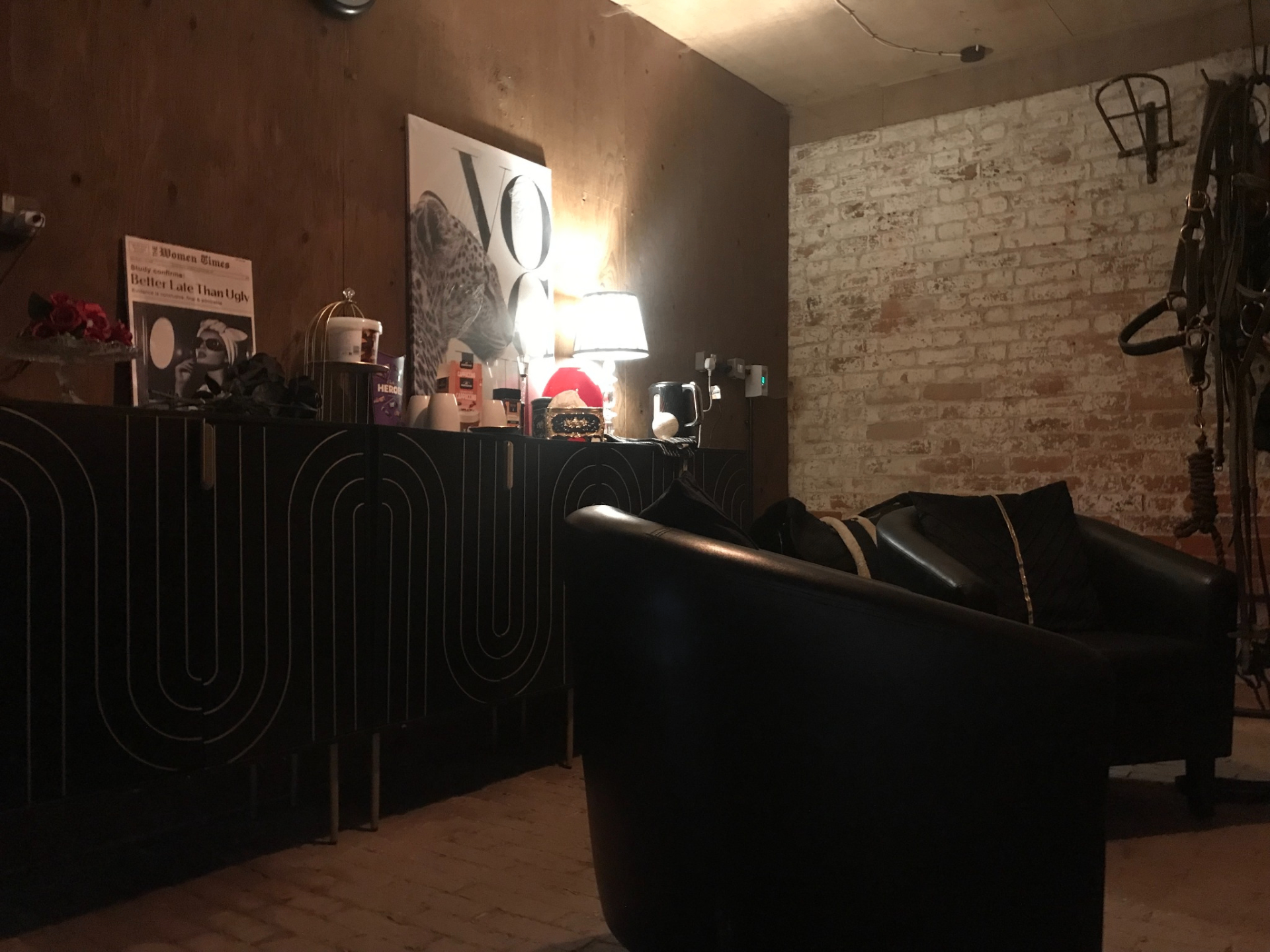 Client lounge with leather seating, exposed brick and curated artwork