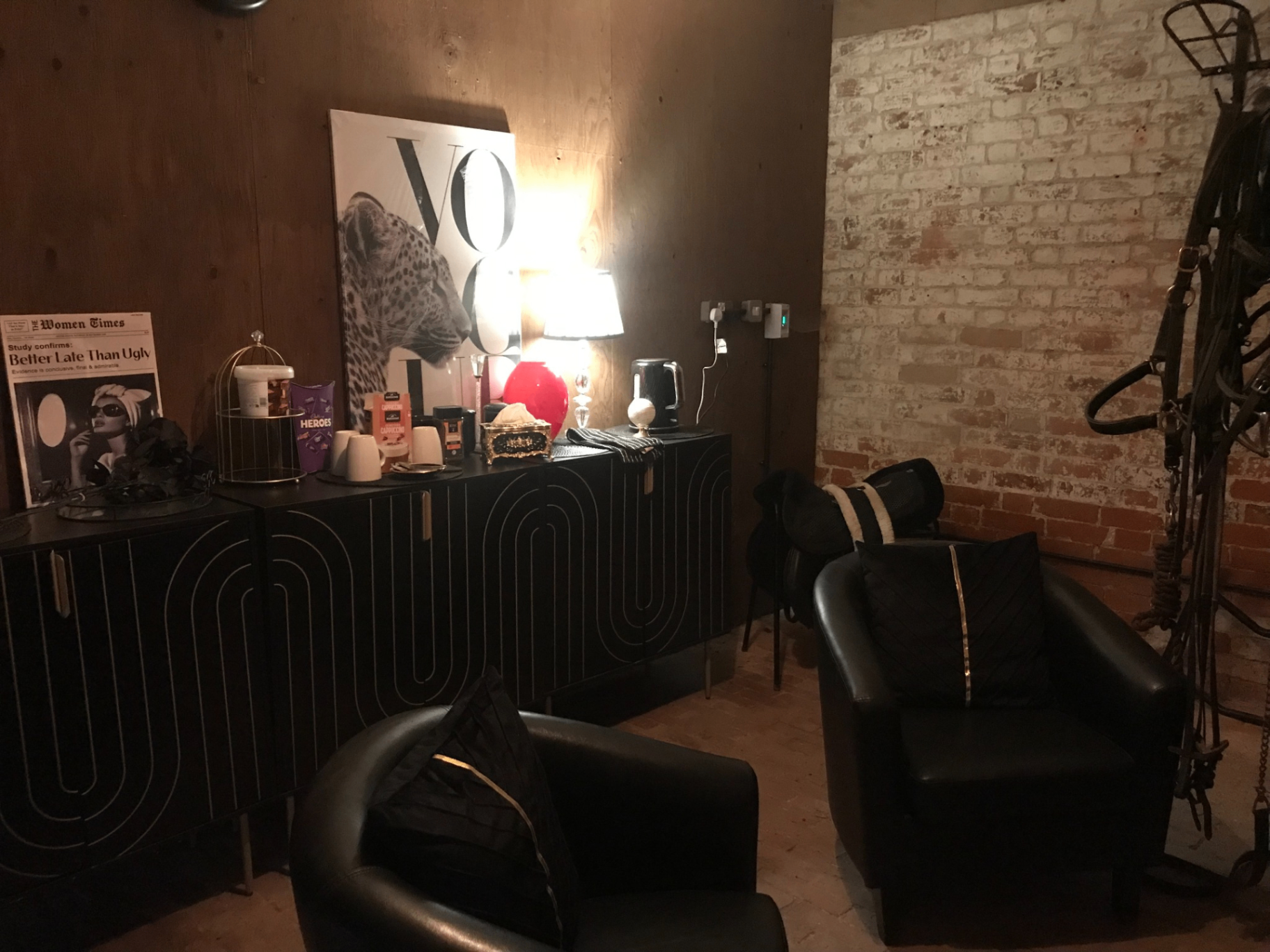 Comfortable client lounge and tack area with saddles and seating